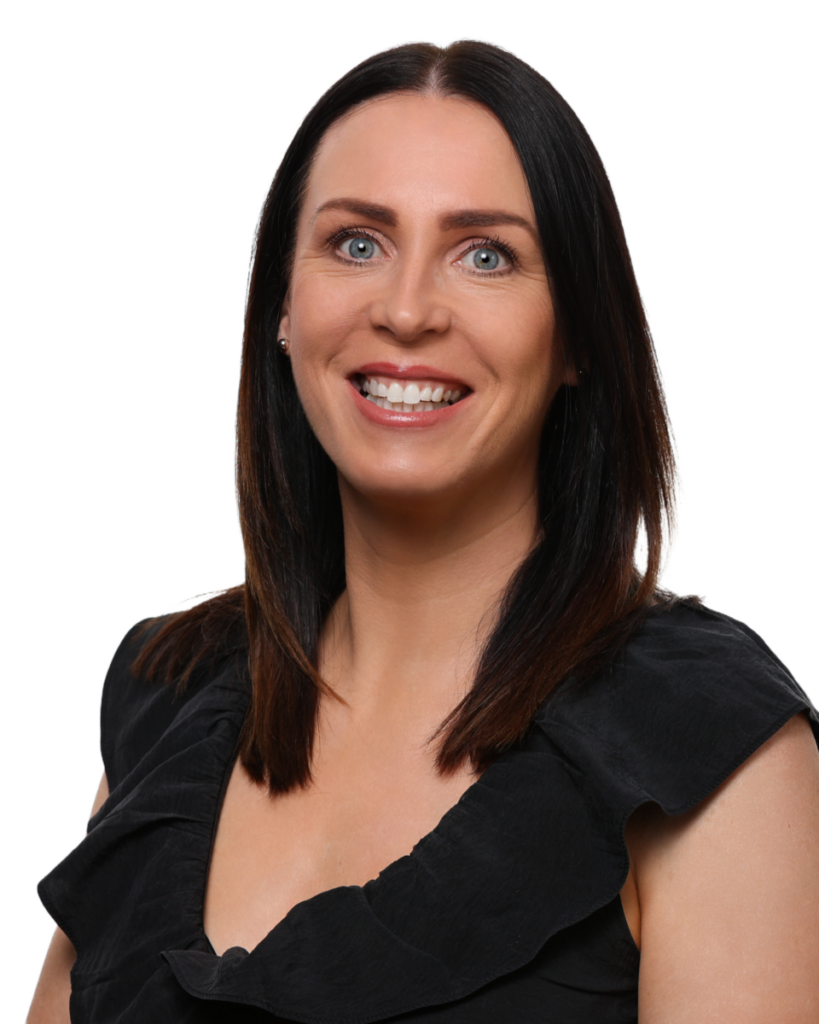Smiling woman with straight dark hair wearing a black top, against a plain background.