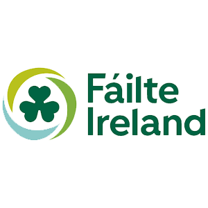 Fáilte Ireland logo featuring a green shamrock surrounded by swooshes, representing Irish tourism and hospitality.